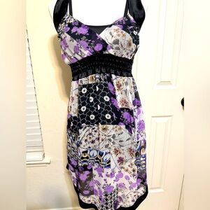 A stunning sleeveless, knee-length sheer floral dress with a V-neckline.